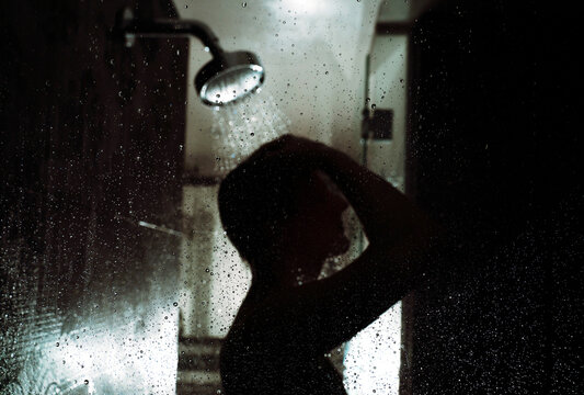 Backlit Showering Man