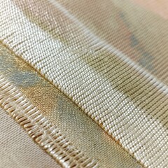 A close-up of a canvas where the weave pattern is visible beneath a thin glaze of color, highlighting the interplay between material and medium.