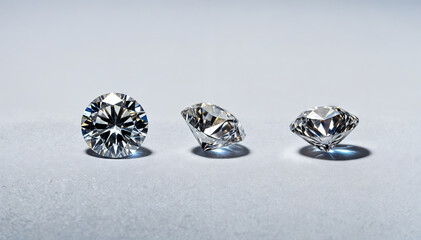 Three distinct diamonds are displayed on a plain white surface, showcasing their varying shapes and cuts