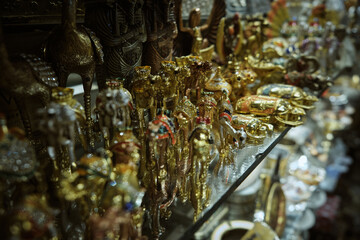 Egyptian souvenir shop. Pharaohs, camels, scarabs and other traditional souvenirs on a shelf of traditional egyptian store shallow focus