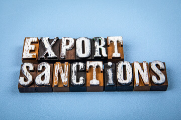 EXPORT SANCTIONS. Wooden alphabet letter blocks on blue textured background