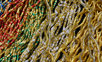background of necklaces made with gold inserts and vibrant hues offering endless customization options in a jewelry store