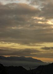 Misty mountain range at sunset in the Andes, foggy landscape background