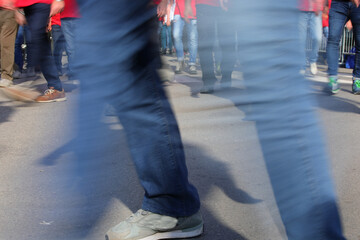 Men walking briskly in the city with blurred motion effect of their legs