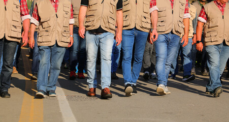 workers in vests walking during a strike participating in a protest demonstration on the street