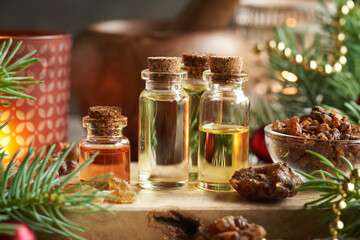 Christmas essential oils with myrrh, frankincense and spruce tree branches