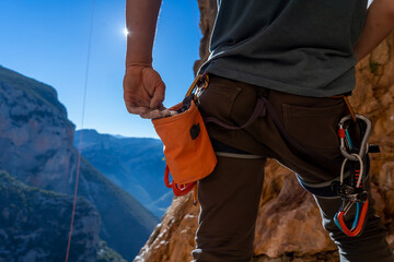 Man is climbing with magnesium powder.