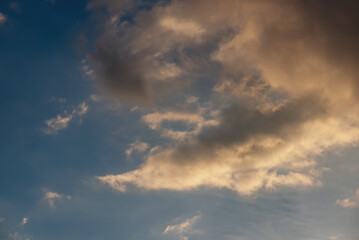 Majestic evening sky with golden clouds at sunset, nature background