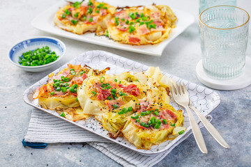 Oven baked cabbage steaks with parmesan, bacon and green onions