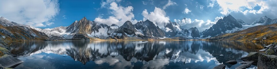 Fototapeta na wymiar mountain range with a lake reflecting the blue sky with dramatic clouds