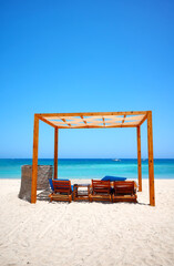 Tropical sandy beach on a sunny day, summer vacation concept.