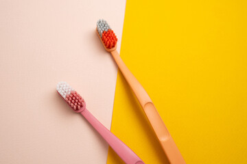 Colored toothbrushes on a color background. Replace your old toothbrush with a new one. Old and new...