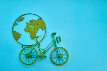 World Bicycle Day. Green Bicycle with World Map Art on Blue Background