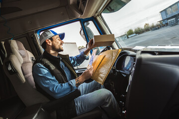 Portrait Of Courier With Delivering Letters. Young handsome delivery guy getting his deliveries ready.
