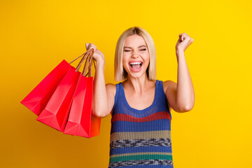 Photo of attractive screaming win lottery blonde hair lady in singlet hold pile bags from shopping...
