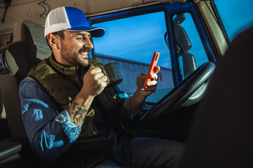 Young handsome man working in towing service and drinking coffee so he could get some energy....