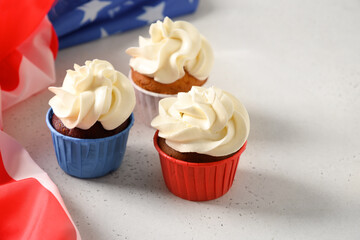 Traditional American three sweet cupcakes in white plate and USA flag. Dessert for Patriotic...