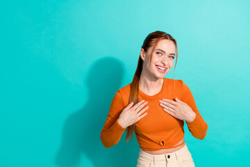 Photo of positive cunning tricky girl with ginger hairdo dressed orange shirt look at offer empty...