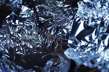 Abstract texture. Glittering aluminum foil. Crushed foil
