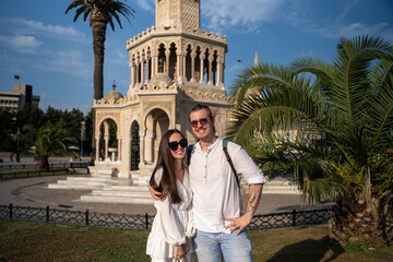 Young happy couple tourists walking have fun in the ancient European city center. Explorers have...