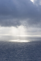 Sun rays and clouds over the Atlantic Ocean.