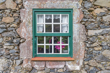 Paned window on a stone building.