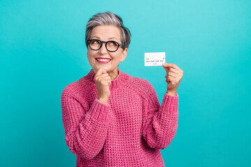 Photo of minded person dressed knitwear sweater in glasses holding debit card look at offer empty...