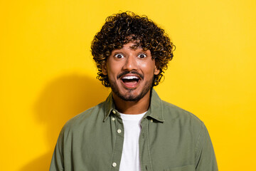 Fototapeta premium Portrait photo of young funny hispanic guy in khaki shirt speechless looking at you unexpected isolated on yellow color background