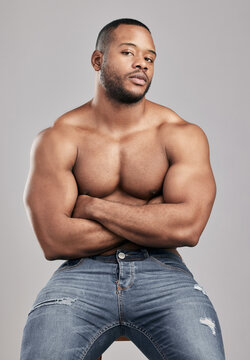 Portrait, body muscle and confident black man in studio for fitness, exercise or health isolated on white background. Abdomen, shirtless or strong bodybuilder with arms crossed for sport in Nigeria