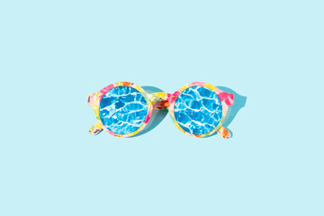 A wave of water in the reflection of sunglasses on a blue background. Summer beach vacation...