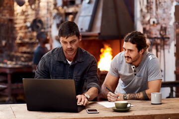 Blacksmith, factory and collaboration with laptop, office and table for work analysis, email or...
