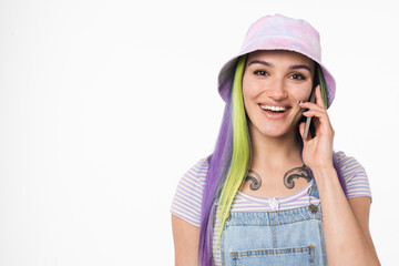 Closeup portrait of young teenage woman girl hipster with colorful dyed hair talking on cellphone...