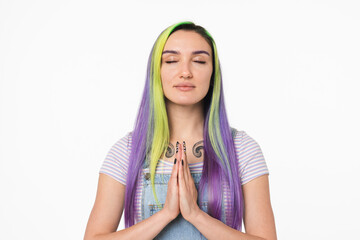 Calm serene young caucasian teenage hipster girl meditating with eyes closed in lotus yoga position...
