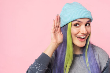 Cropped closeup portrait of a young caucasian curious hipster girl overhearing rumors secrets with...