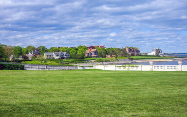 view of mansions across the lawn and water