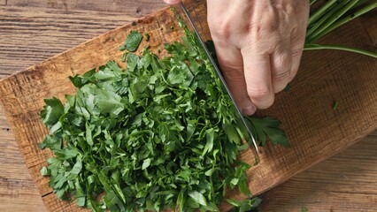 Chef chops fresh green parsley
