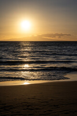 Warm sunset over the Pacific Ocean from the beach at Kihei, Maui, Hawaii, as a nature background
