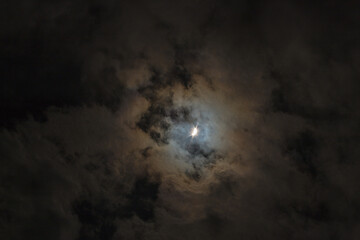 Near total eclipse of the Sun. The moon covers the sun in a solar eclipse and cloudy dramatic sky. Nature phenomenon. 