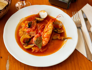 Seafood dish. Tasty tail of monkfish braised with shellfish, prawns and vegetables..