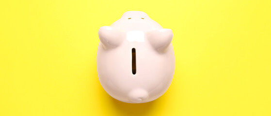 Piggy bank on yellow background. Money saving concept