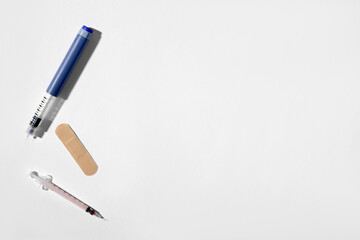 Empty syringes with plaster on white background
