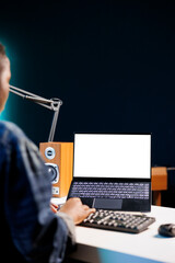 Black woman working from home at a desk with wireless computer displaying an isolated white screen....