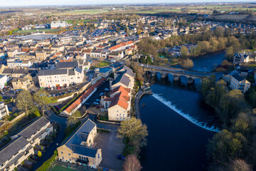 Aerial photo of the town centre of Wetherby in West Yorkshire in the UK, showing the River Wharfe with traffic driving over the small bridge that leads in to the town centre, taken in the winter.
