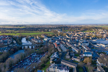 Fototapeta premium Aerial photo of the town centre of Wetherby in West Yorkshire in the UK, showing the River Wharfe with traffic driving over the small bridge that leads in to the town centre, taken in the winter.