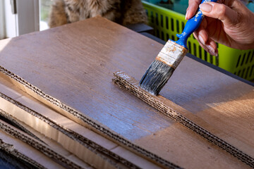 Corrugated cardboard stripes are glued together in several layers using PVA glue and brush....