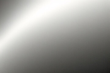 A tight shot of a polished metal surface adorned with a silver pattern, overlain by silver metallic foil
