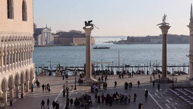 People at St Mark's Square. Boats in the venetian lagoon in the background; Venice, Italy