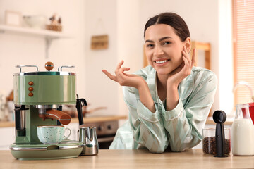 Beautiful young happy woman with modern coffee machine and jar of fresh beans in kitchen
