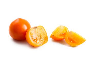 Cut and whole of yellow tomato isolated on white background.