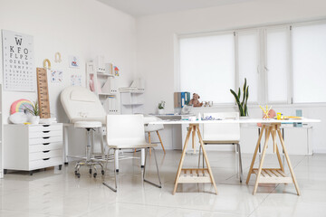 Interior of pediatrician's office with workplace and couch